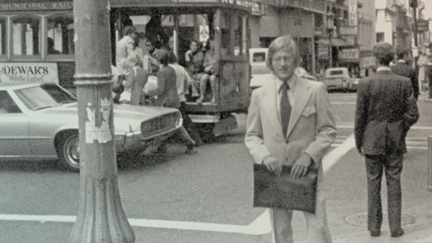 Photo of David Booth on the street holding a portfolio case.