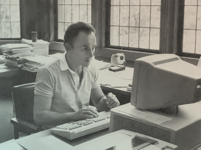 Photo of Eugene Fama sitting at a computer.