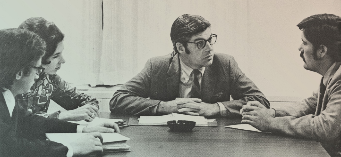 Photo of Mac McQuown sitting at a table.