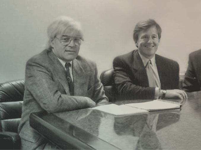 Photo of Mac McQuown and David Booth sitting at a table.